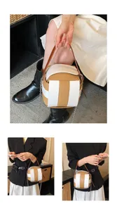 Detailansicht der trendigen, farbblockierten Würfel-Handtasche mit Kette und Henkel