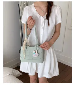 Casual light green tote bag detail with cute rabbit pendant and lace bow for summer.