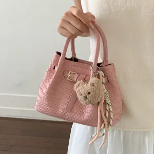 Rosa gewebte Leder Handtasche für Damen, stilvolle Umhängetasche mit Bärenanhänger.