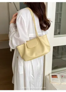 Vista detallada del bolso de hombro minimalista y casual para mujer en color amarillo.