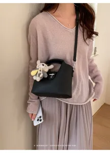 Schicke schwarze Leder-Beuteltasche mit Bärenanhänger, stilvolle Damen Handtasche für Pendler.
