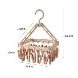 Pratico stendibiancheria pieghevole in plastica per calze con tante mollette utili sul balcone.