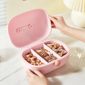 Pink multi-compartment storage box for kids, cute hair accessories organizer with neat layout.