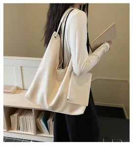Detailed shot of a women's large capacity beige shoulder tote bag with a small pouch.