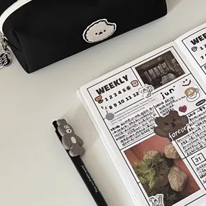 Detail view of black canvas pencil case with cute puppy patch, large capacity stationery storage.