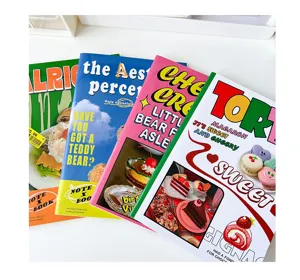 Retro aesthetic cute cartoon stapled notebook detail showing colorful covers and illustrations.