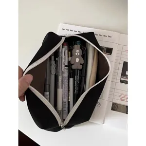 Black canvas pencil case with large capacity, durable zipper pouch for school stationery.