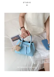 Trendy light blue woven leather handbag bucket bag for women, chic stylish crossbody tote.