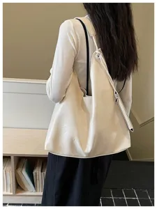 Detailed shot of an off-white slouchy shoulder tote bag, stylish and practical for women.