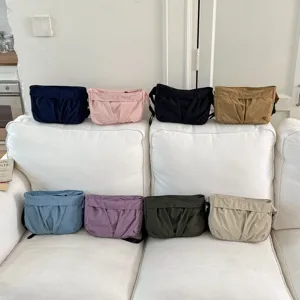 Detailed view showing multiple colored canvas casual shoulder crossbody bags arranged neatly.