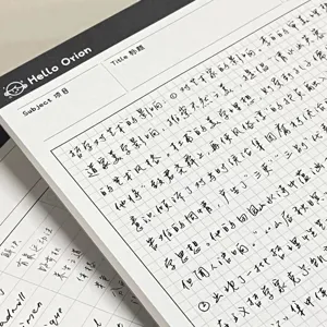 B5 grid notepad detail shot showing minimalist tearable paper and clear handwriting notes.