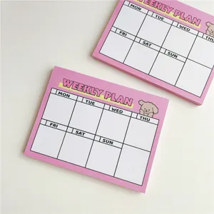 Cute pink weekly plan notepad detail showing days and adorable puppy illustration.