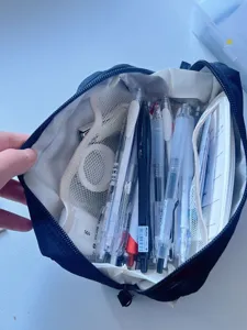 Large capacity dark blue canvas pencil case with multiple compartments for stationery storage.