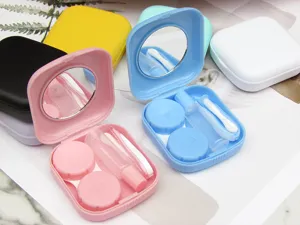 Detailed view of portable contact lens case with mirror, tweezers, and solution bottle.