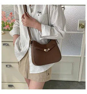 Stylish vintage brown leather shoulder bag for women, chic crossbody bag with metal lock.