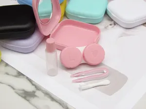 Close-up detail of a portable contact lens case kit with mirror, tweezers, and solution bottle.