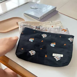 Detailed view of cute Japanese style cat embroidery canvas pouch for daily cosmetic storage.