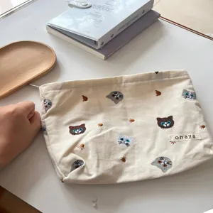 Detail view of the cute cat embroidered canvas makeup pouch, showcasing fine stitching and fabric.