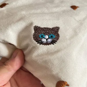 Japanese style cute canvas makeup bag with embroidered cat design, portable cosmetic pouch.
