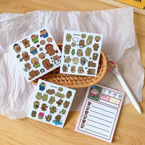 Detail view of cute Korean style brown bear cartoon stickers and memo pad for journal planning.