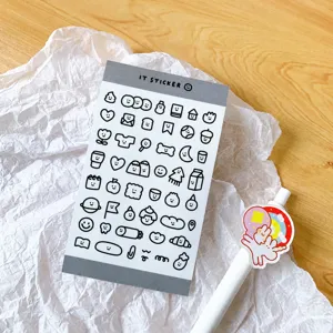 Close-up detail of cute black and white cartoon daily doodle sticker sheet for journal decor.