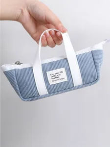 Corduroy mini tote pencil case with cute handle and custom label detail close up view.