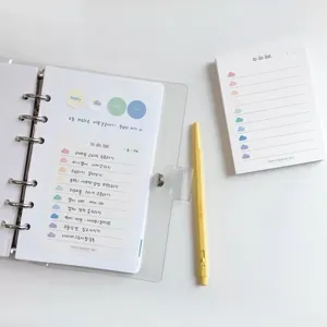 Gedetailleerd overzicht van Koreaanse stijl todo list notitieblok en transparante map op bureau.