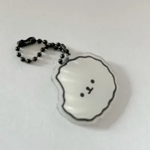 Cute cartoon puppy acrylic keychain detail view, featuring clear pendant and black bead chain.