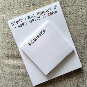Detail of funny quote sticky notes, creative memo pad close up view, white paper stationery.
