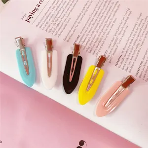 Close-up detail of colorful sectioning hair clips in pastel tones. Perfect makeup and styling set.