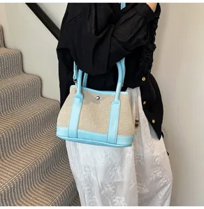 Stylish canvas handbag with contrast leather trim, versatile tote bag for women daily wear.