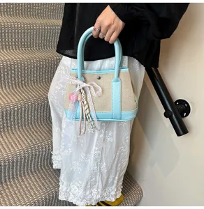 Canvas color-blocking handbag with cute lace ribbon charm, mini fashion tote bag for daily casual wear.