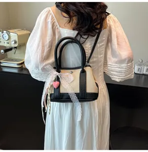 Chic contrast canvas crossbody bag with lace ribbon and cute heart pendant for women fashion style.