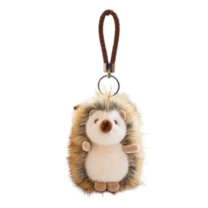 Cute hedgehog plush keychain soft stuffed animal bag charm with brown braided strap.