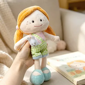 Cute plush rag doll with orange hair and green plaid overalls, soft stuffed companion toy for kids.