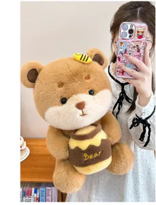 Close-up detail of cute brown plush bear holding honey pot with soft fur and bee decor.