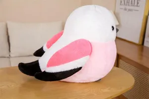 Close-up detail of the chubby bird plush toy, showing soft pink and white fur texture.