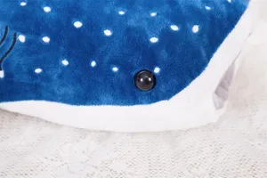 Close-up detail of cute whale shark plush toy pillow, soft blue fabric with white spots.