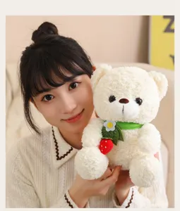 Cute cream plush bear detail shot, soft texture, green collar and strawberry toy, warm style.
