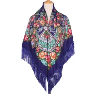 Detailed view of the traditional floral pattern and elegant fringe on this ethnic shawl.