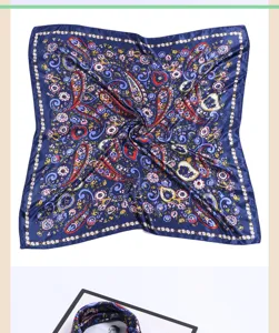 Detailed view of blue silk scarf featuring exquisite paisley and floral prints, elegant design.
