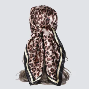 Detailed view of 90x90cm classic leopard print square scarf showcasing silky texture and border.