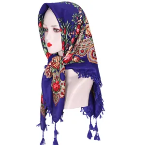 Blue floral pattern headscarf detail, traditional Central Asian style scarf with tassel trim.