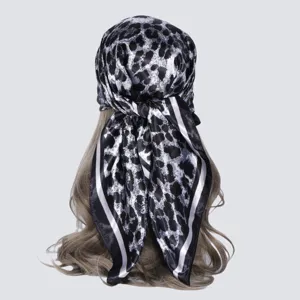 Detailed back view of a black and white leopard print imitation silk square scarf.