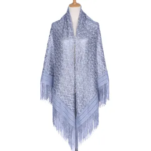 Detailed view of the light blue hollow lace shawl featuring elegant tassel trim and texture.