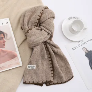 Cozy knitted winter scarf for women, chic wool-blend design with contrast color stitching.