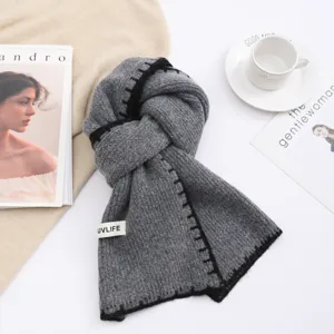 Grey wool blend winter knitted scarf with black contrast stitching and brand label.