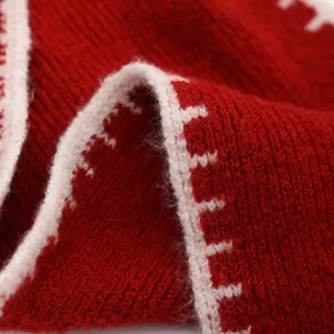 Detailed close-up of a cozy red knitted wool scarf with white border for winter warmth.