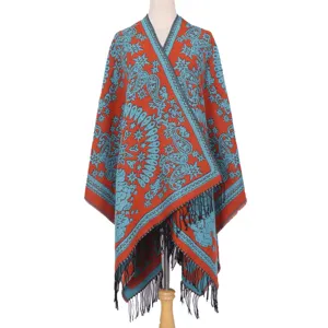 Detailed view of women thick warm imitation cashmere shawl cloak with blue paisley patterns.
