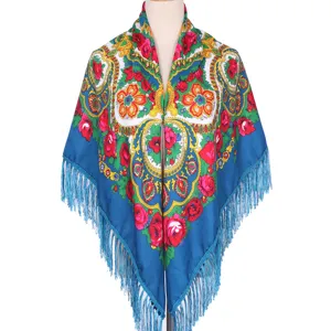 Detailed shot of ethnic floral fringe shawl, traditional Russian style blue square scarf.